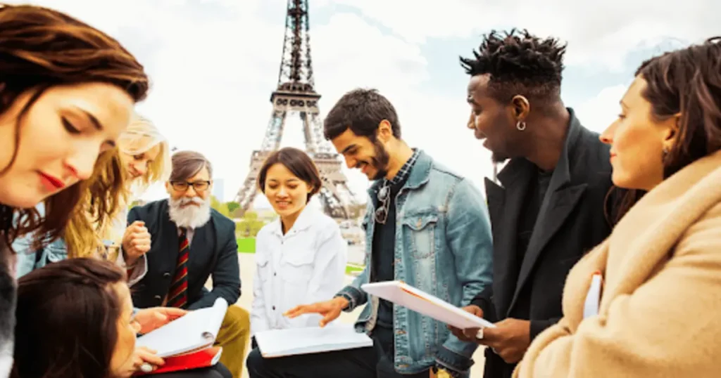 Multicultural group in Paris, considering the cost to study in France.