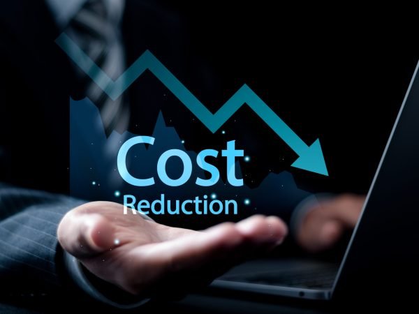 Cost reduction Concept. Businessman use laptop and holding graph with down arrow icon for budget management and cost management.