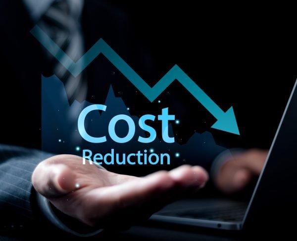 Cost reduction Concept. Businessman use laptop and holding graph with down arrow icon for budget management and cost management.
