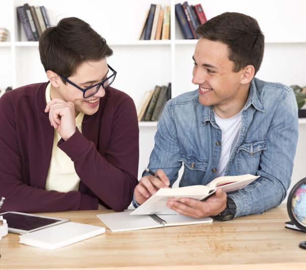 smiling-students-reading-book